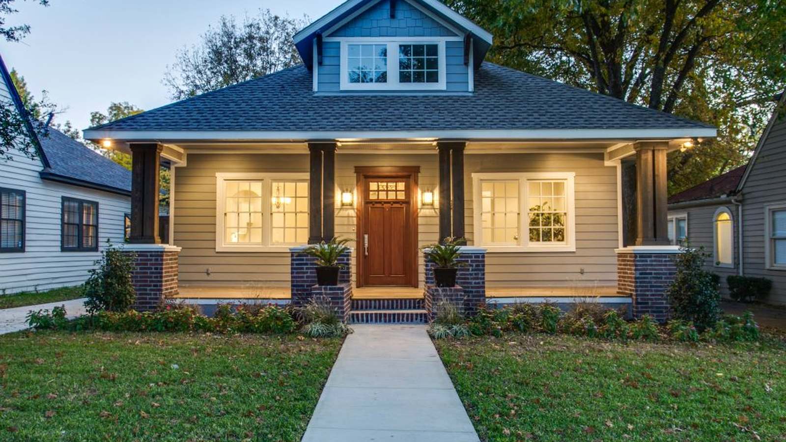 A restored craftsman home in Fort Worth, lit at dusk