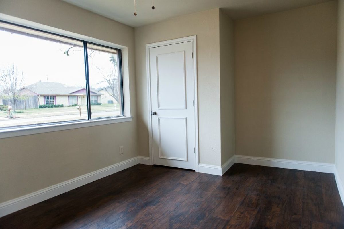 A bedroom, with the floors refinished.