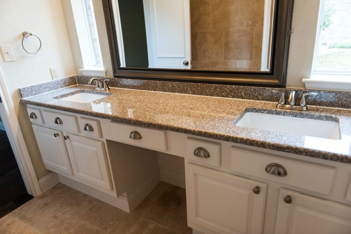 Double vanity and mirrored wall.